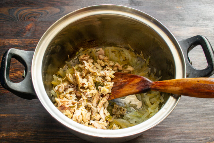 Diced cooked chicken meat being added to the pot
