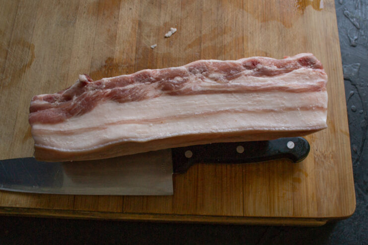 Preparing salo for curing Fresh piece of pork fatback on a cutting board