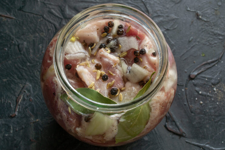 Aromatic additions Bay leaf and whole spices on top of the meat