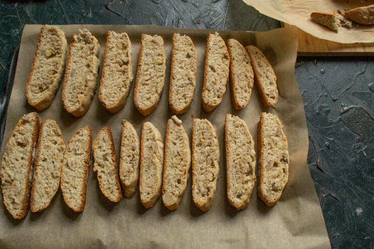 Preparation for the second bake Biscotti slices arranged flat on a baking sheet for drying