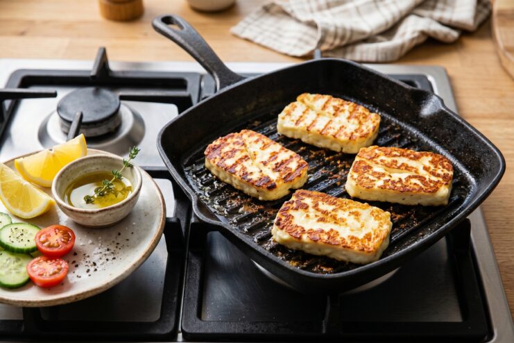 Fried Halloumi Cheese Thick slices of Halloumi cheese pan-fried to a golden brown crust on a grill pan.