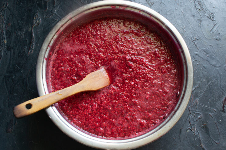 Heating the berry mass Raspberry puree in a pot before heating