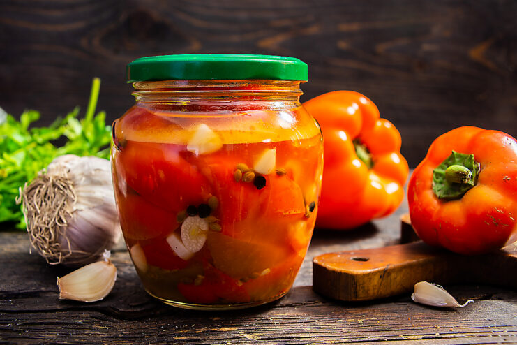 Pickled sweet Gogoshari peppers in a glass jar ready for winter