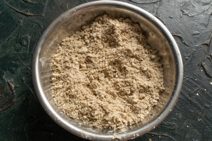 Rubbing the dough base Butter and flour mixture rubbed into coarse crumbs in a metal bowl