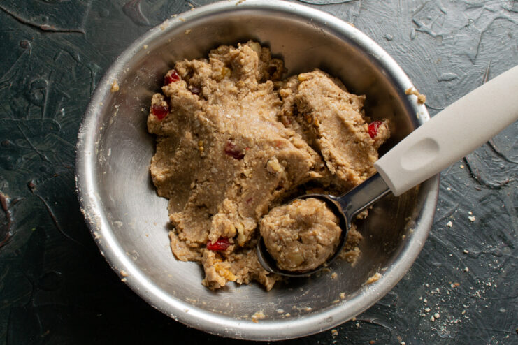 Portioning the dough Measuring spoon scooping oatmeal cookie dough from a mixing bowl