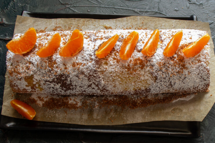 Final decoration Decorating the marble Swiss roll with mandarin segments