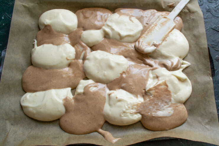 Creating the marble effect Swirling vanilla and chocolate batter together on a baking sheet