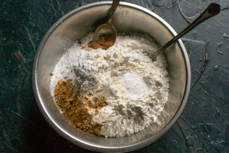 Mixing dry ingredients Flour mixed with cinnamon and ginger spices in a bowl