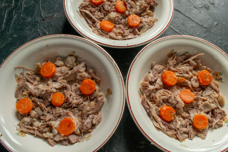 Portioning Meat and carrots portioned into plates for the aspic.