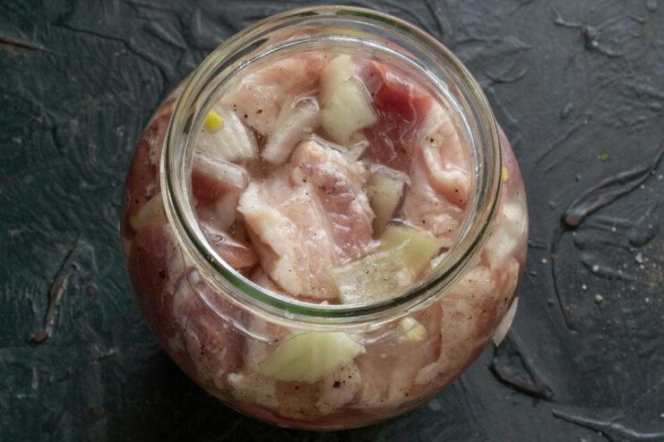 Adding water Meat in a glass jar submerged in cold water