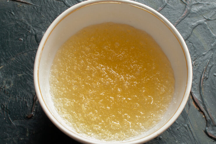 Working with Gelatin Bloomed gelatin with water in a small white bowl.
