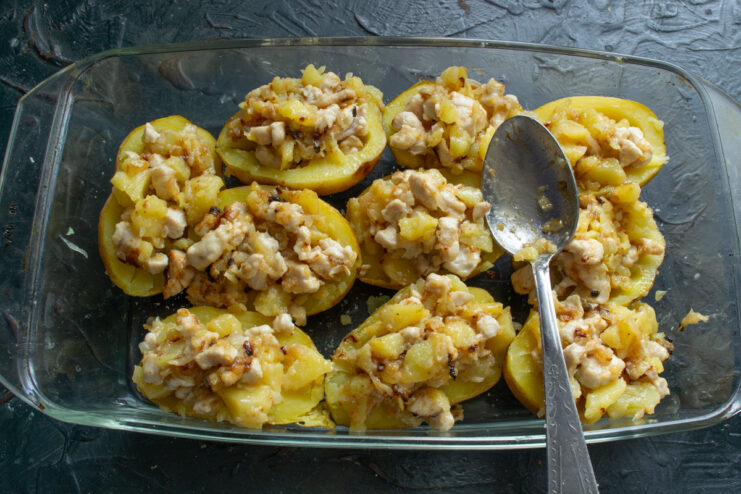 Stuffing the potatoes Stuffing potato halves with the chicken and potato mixture