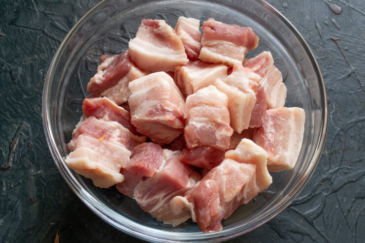 Prepping the pork Diced pork belly in a bowl