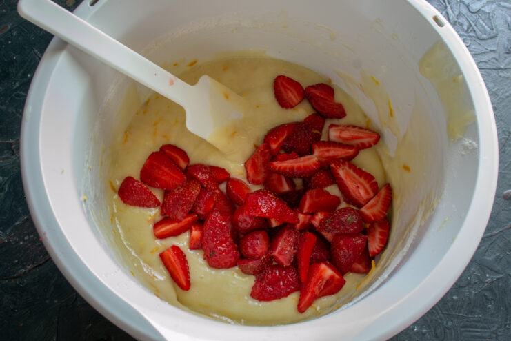 Adding strawberries Chopped fresh strawberries in cake batter