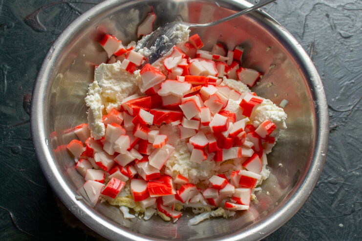 Dicing the crab sticks Diced crab sticks in a bowl with eggs and cream cheese
