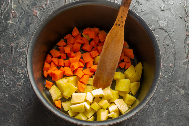 Preparing vegetables for the soup Diced carrots and potatoes placed in a soup pot
