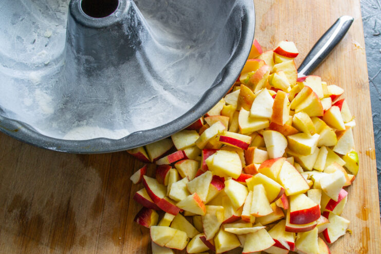 Preparing apples and baking pan Diced apples next to a greased tube baking pan