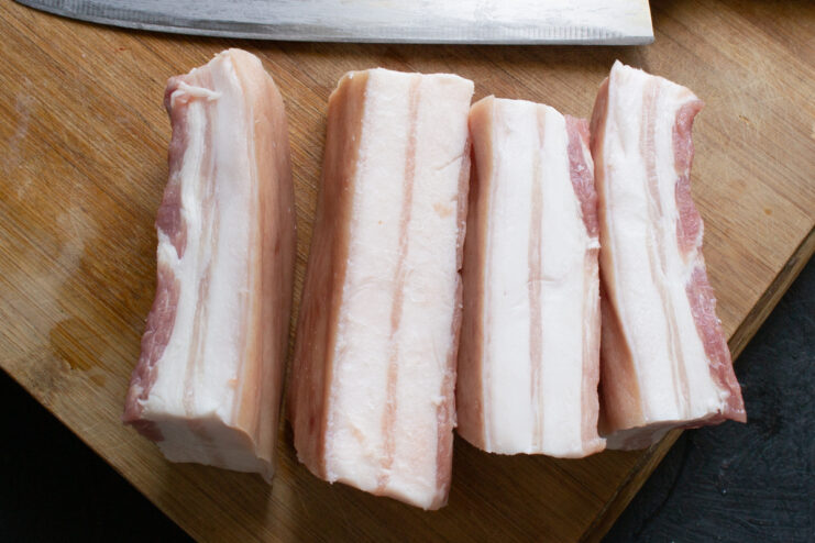 Slicing salo into portions Sliced strips of pork fat ready to be packed into the jar