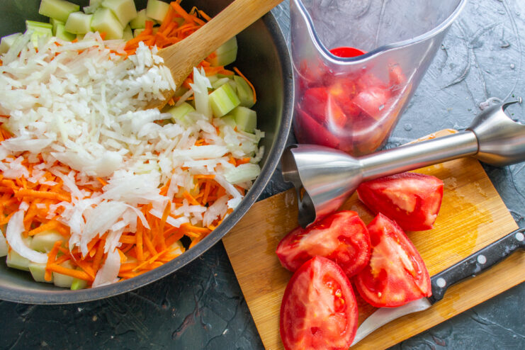 Fresh tomato quarters and an immersion blender