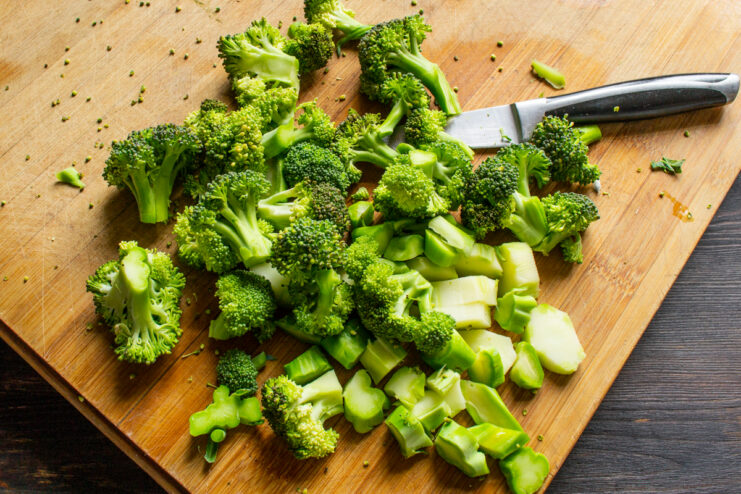 Chopping the broccoli Chopped broccoli florets and peeled stems on a cutting board
