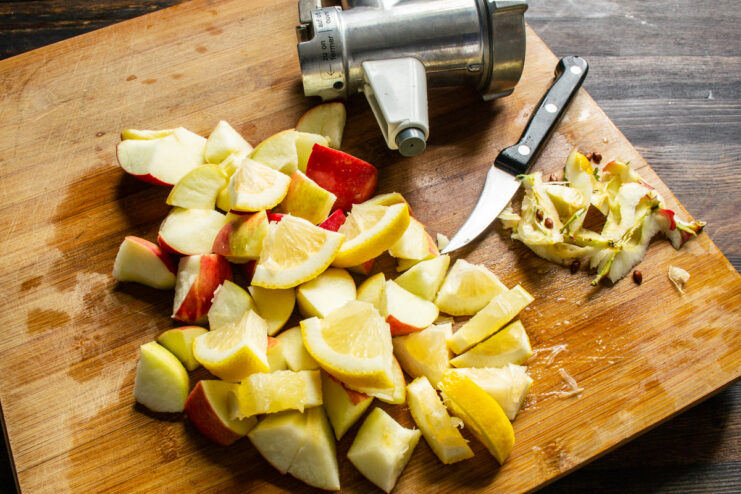 Preparing the fruit filling Chopped apples and lemon on a wooden cutting board for the fruit filling.