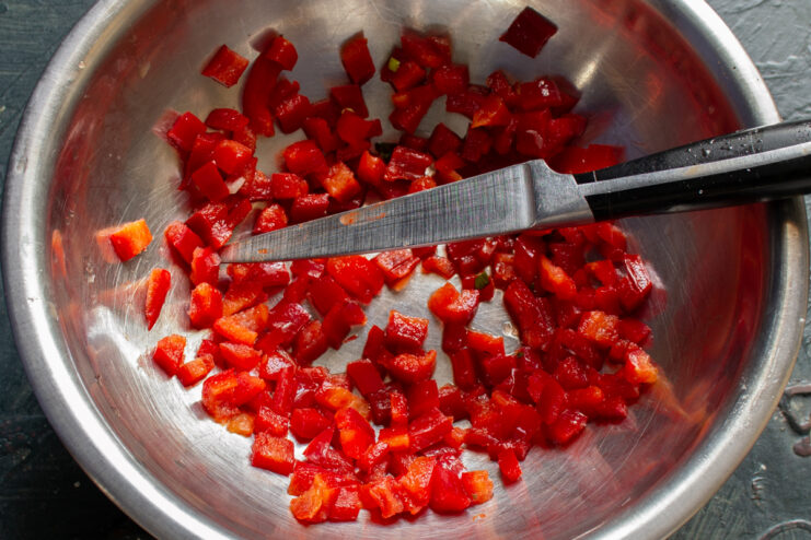 Dicing The Pepper Diced bell pepper on a cutting board