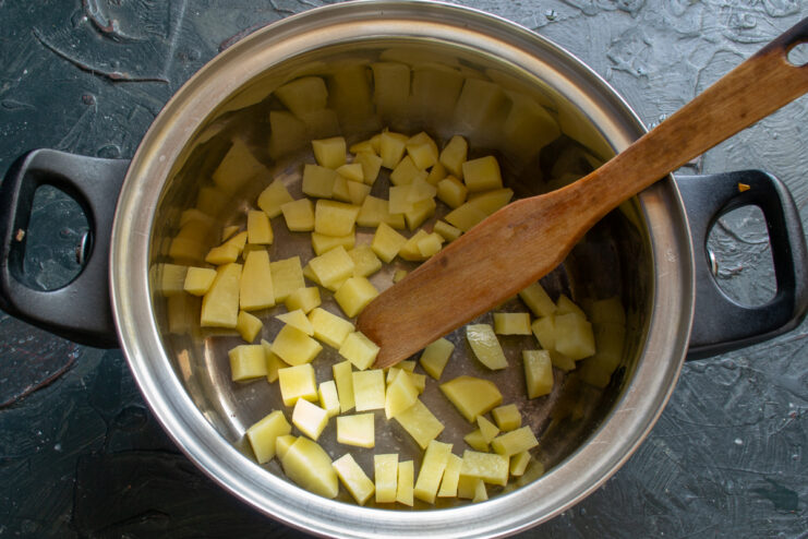 Adding Potatoes to the Soup Diced potatoes resting in a cooking pot