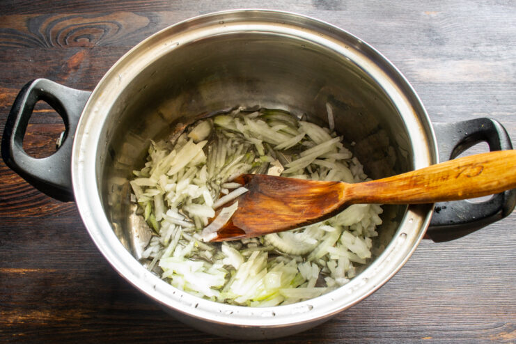 Chopped onions sautéing in a heavy-bottomed pot