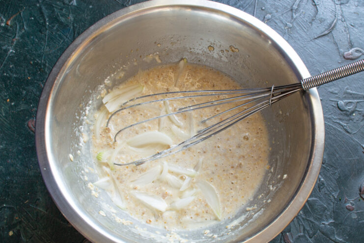 Adding onions to the batter Finely chopped onion mixed into the oatmeal pancake batter