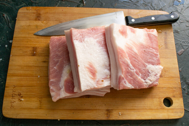 Slicing the salo Slicing a large slab of raw pork fat into smaller blocks for curing