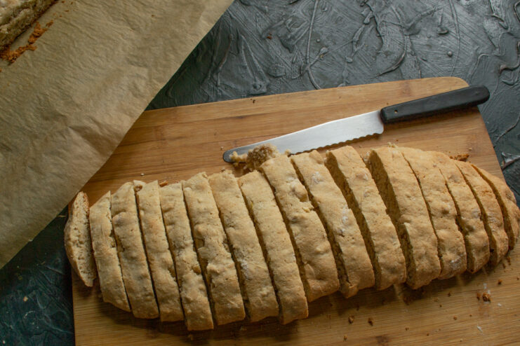 Slicing the logs Slicing a baked dough log into pieces with a serrated knife