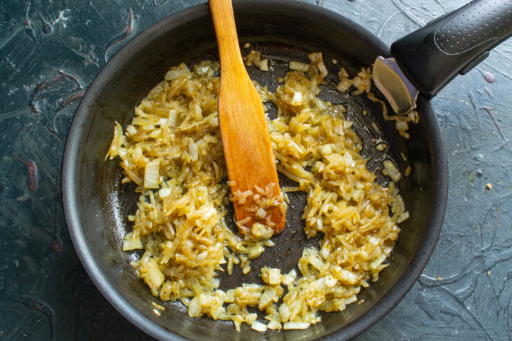 Sautéing onions with spices Sautéed onions with khmeli suneli in a skillet