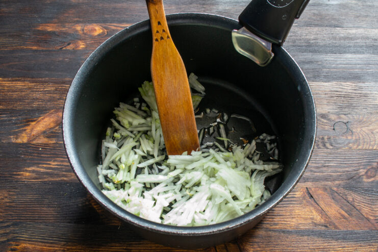 Sautéing the onion Sautéing diced onions in a saucepan