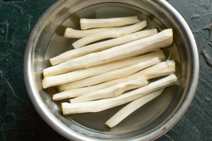 Soaking peeled horseradish roots Peeled white horseradish roots soaking in a bowl of cold water.
