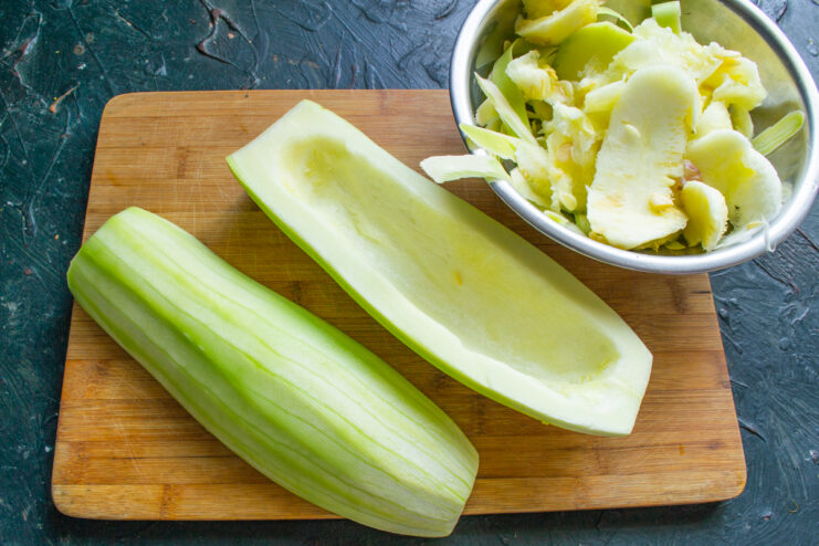 Peeled and seeded zucchini halves on a cutting board