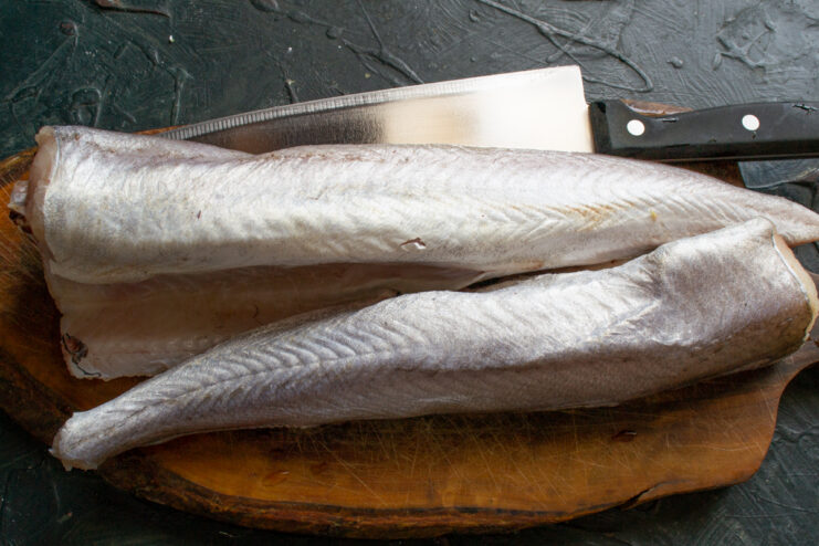 Prepping the Fish for the Soup Cleaned whole fish lying on a wooden cutting board
