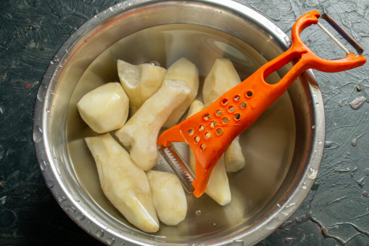 Storing the peeled sunchokes Peeled Jerusalem artichokes soaking in a bowl of cold water