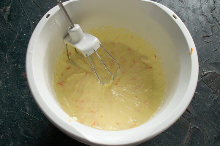 Smooth and homogeneous cheese filling with orange zest in a bowl