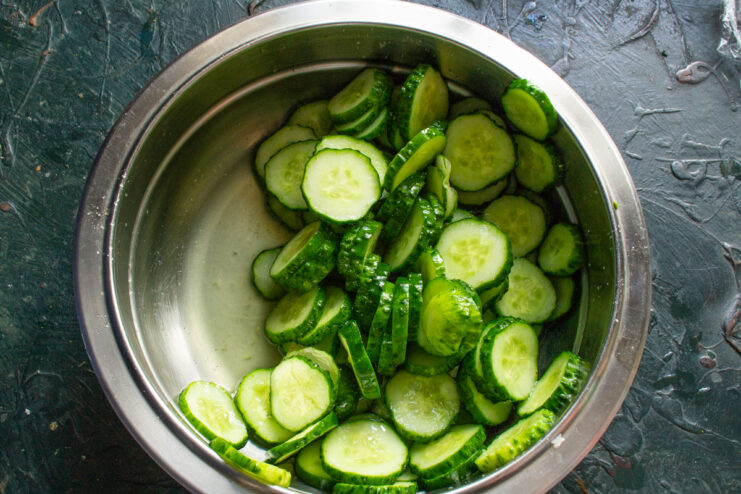 Cucumbers Releasing Juices Cucumbers in a metal bowl sitting in their own juices after several hours of salting