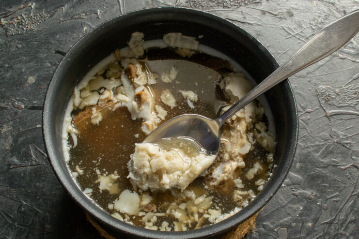 Skimming fat from broth Removing solidified fat from chilled meat broth