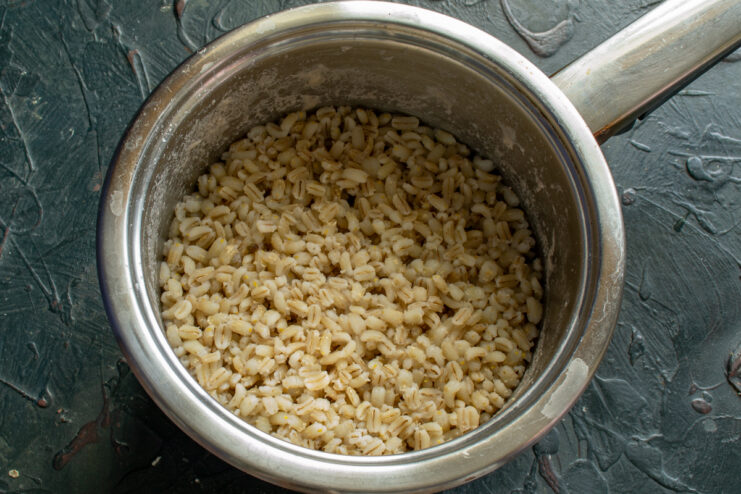 Cooking The Pearl Barley Fully cooked pearl barley in a saucepan