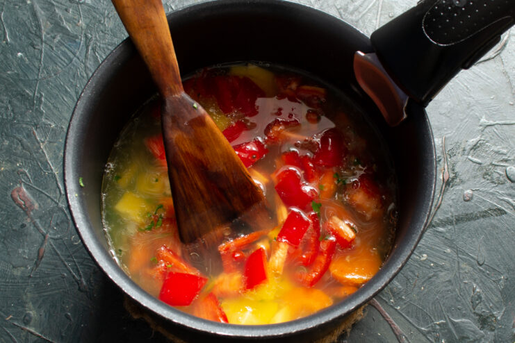 Boiling the vegetable base Vegetables simmering in fish broth in a soup pot