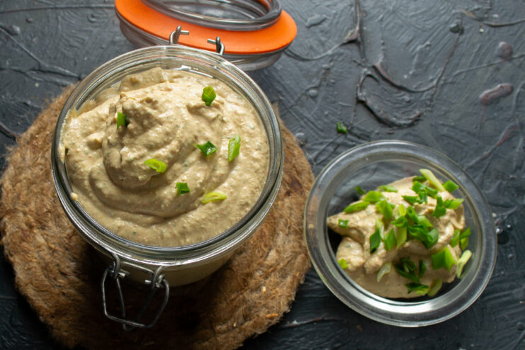 Storing the prepared pâté Savory pâté in a glass jar sprinkled with fresh green onions