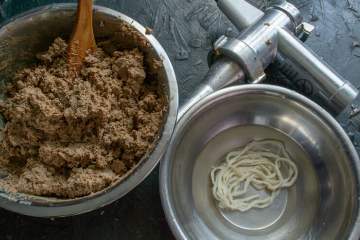 Prepping The Sausage Casings Prepared liver sausage farce and rinsed pork casings in bowls