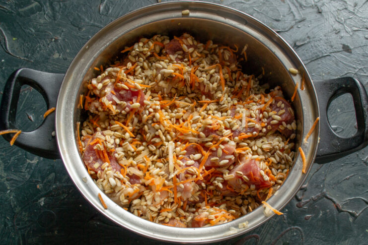 Mixing the filling Mixed pork, pearl barley, and vegetables inside a pot