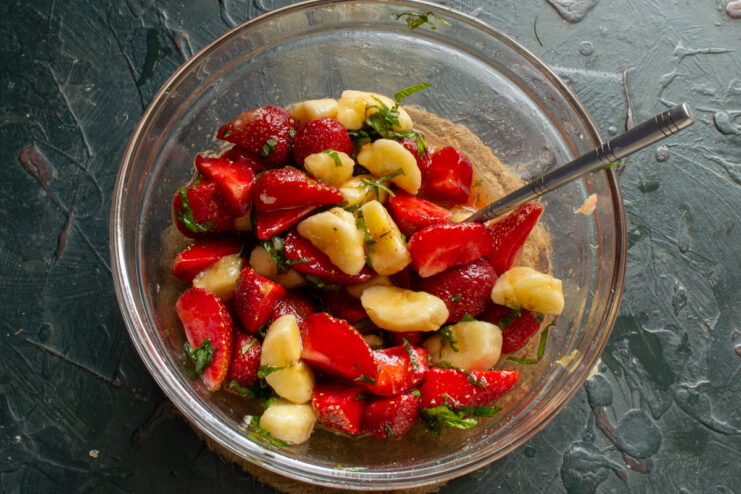 Mixing The Fruit Salad Gently stirring the fruit salad with a spoon