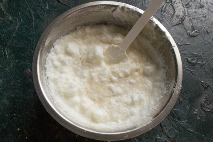 Airy sponge cake batter Gently folding the cake batter with a silicone spatula until smooth