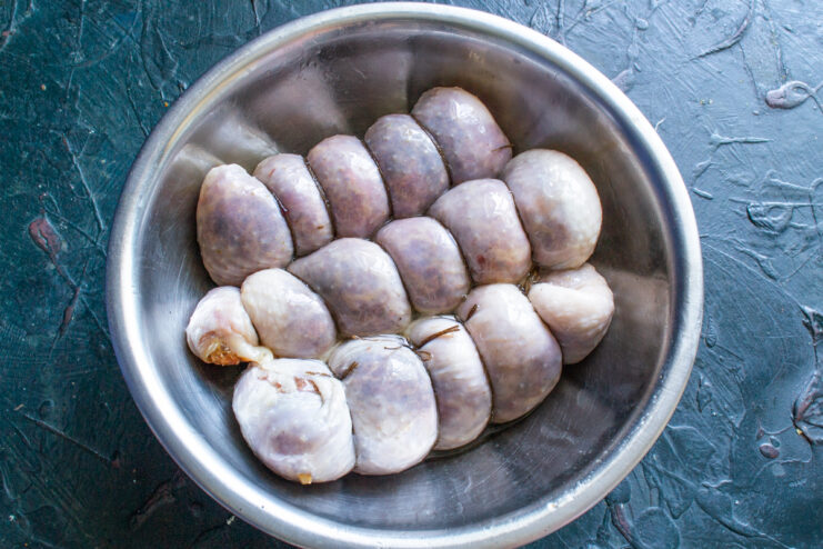 Prepping For The Pan Tied sausages in a bowl drizzled with cooking oil