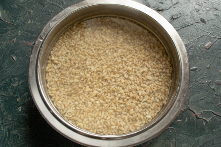 Soaking pearl barley Pearl barley soaking in water inside a metal bowl