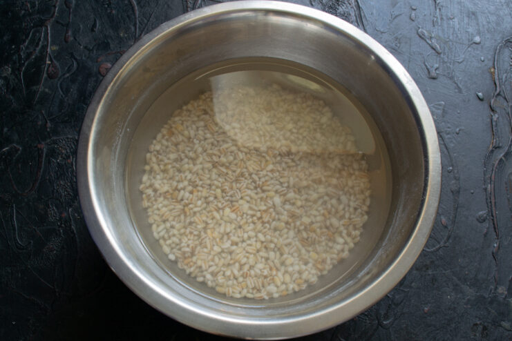 Soaking the barley Pearl barley soaking in water in a metal bowl